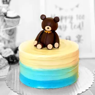 a teddy bear on top of a cake