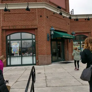 a woman walking down the sidewalk