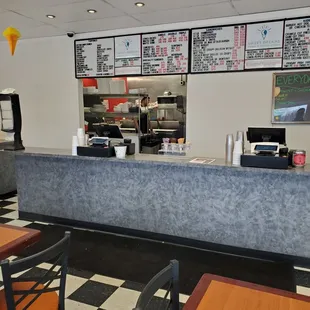 a restaurant counter with a checkered floor