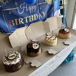 a variety of birthday cakes on a table