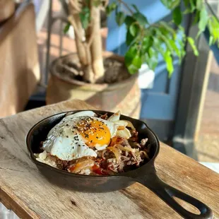 Mama Hwang&apos;s Bulgogi Skillet - Rib-eye marinated in Mama Hwang&apos;s sweet soy sauce.caramelized onion &amp; housemade gochujang sauce