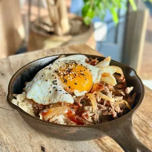 Mama Hwang&apos;s Bulgogi Skillet - Rib-eye marinated in Mama Hwang&apos;s sweet soy sauce.caramelized onion &amp; housemade gochujang sauce