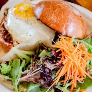 a plate of food with a sandwich and salad