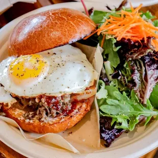 a plate with a sandwich and salad