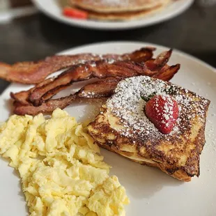 The perfect breakfast.  One banana and cream cheese stuffed French Toast, Scrambled Eggs, and Bacon