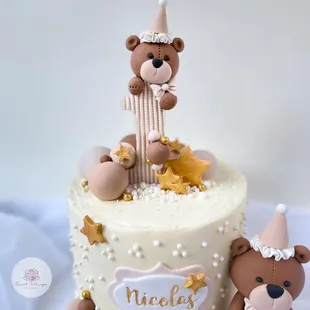 a cake with a teddy bear on top