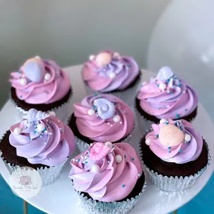 chocolate cupcakes with pink frosting and sprinkles