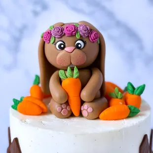 a cake decorated with a bunny and carrots