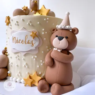 a birthday cake with a teddy bear
