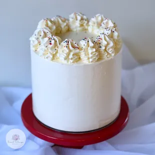 a cake with white frosting and sprinkles