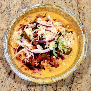 Their Nachos sauce has a fiery cheese sauce, their Original BBQ Sauce, pico de gallo, jalapeños and creamy coleslaw.