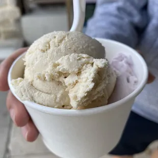 a person holding a cup of ice cream