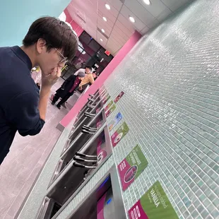 a man looking at a display of toilet paper