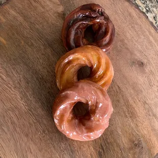 French doughnuts with chocolate, lilikoi, and guava, icing.