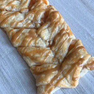 Salted caramel apple Kringle made with homemade real butter caramel drizzle.