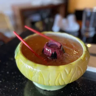 a yellow bowl with a spoon sticking out of it