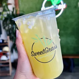 a hand holding a cup