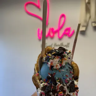 Cookie Monster, chocolate ice cream with a vanilla bubble waffle with sprinkles, oreo crumbles, chocolate waffle pieces with whipped cream