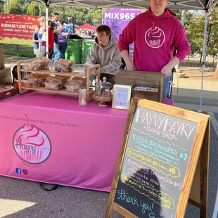 a woman standing behind a table