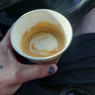 a hand holding a cup of coffee