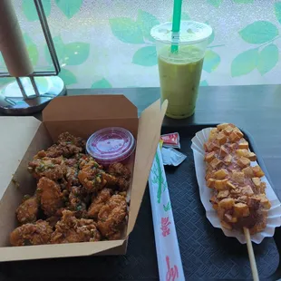 two trays of food and a drink