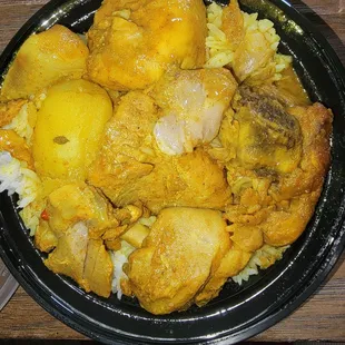 Curry chicken with white rice, carrots, potatoes, and cabbage.