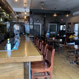 a restaurant with wooden tables and chairs