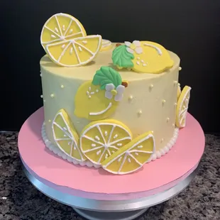Lemon velvet cake with buttercream frosting and handmade sugar paste decorations