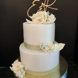 Vanilla velvet cake with buttercream frosting and strawberry reduction filling- handmade sugar paste flowers