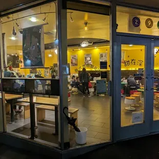 a cafe with a cat sitting in the window