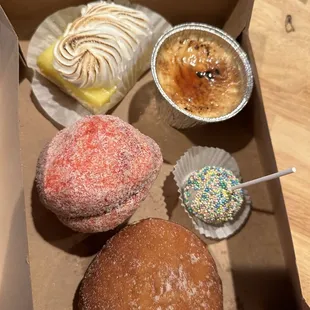 Left to right, top to bottom- lemon bar, crème brûlée, strawberry yoyo, vanilla cake pop, Bavarian cream donut.