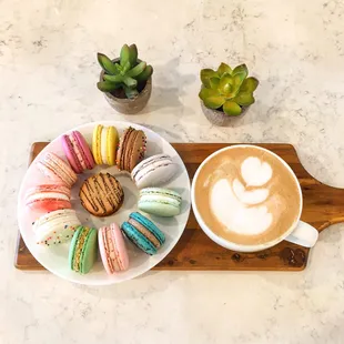 a plate of macarons and a cup of coffee