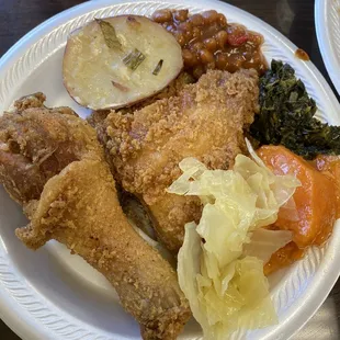 a plate of fried chicken and vegetables