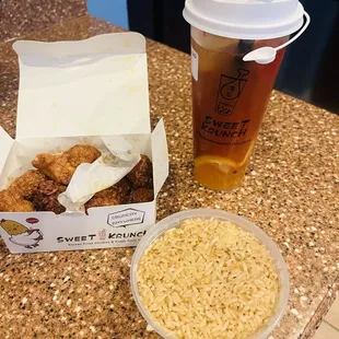 Boneless  wings 10 count half spicy and half soy garlic and plain fried rice for a side with super fruit tea with mango boba