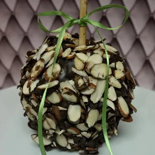 a chocolate covered apple with almonds