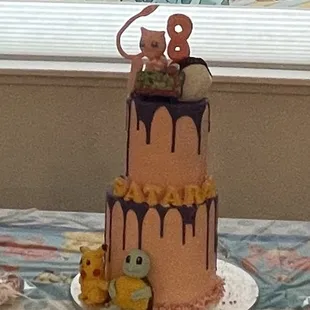 a birthday cake and cupcakes