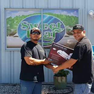 Winner of our Grand Opening raffle prize. Rene with our General Manager Carlos!