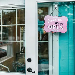 a pink sign hanging from the front door