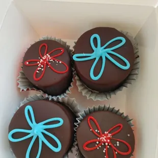 four chocolate cupcakes in a box