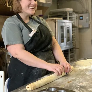 a woman rolling out dough