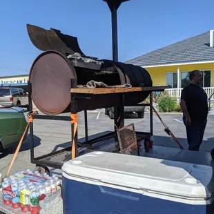 a man standing in front of a bbqq