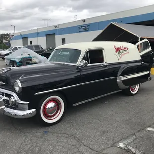a classic car parked in a parking lot