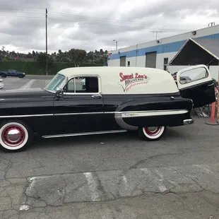 a black and white car parked in a parking lot