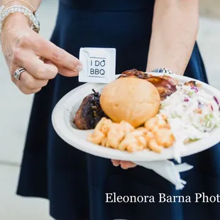 a woman holding a plate of food