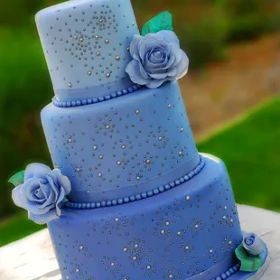 a three - tiered blue cake