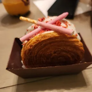 a croissant roll with icing and strawberries