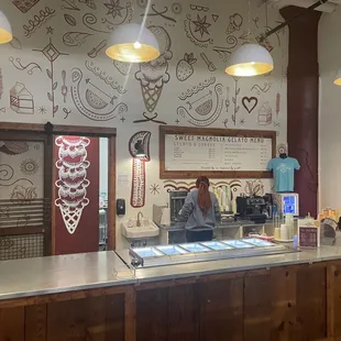 a woman behind the counter of a cafe