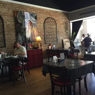 a dining room with a brick wall