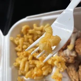 a fork picking up some macaroni and cheese