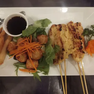 Shushami, chicken satay, shrimp in a blanket and a carrot flower.